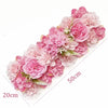 A long panel of pink artificial silk rose flowers used for weddings and events.