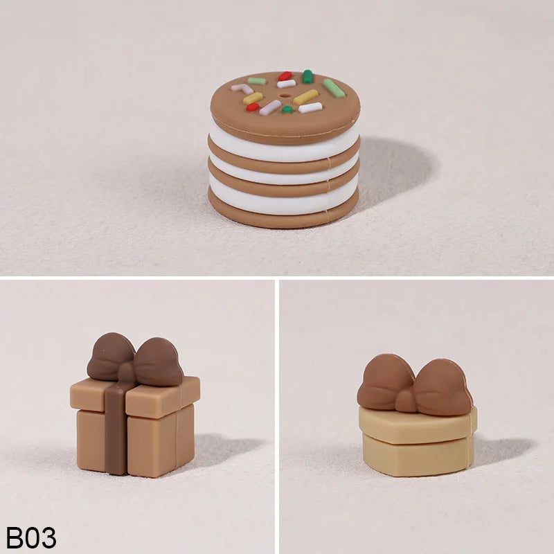 A set of three round, stacked cake toppers in brown and white frosting with colorful sprinkles.