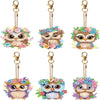 A set of DIY diamond painting owl keychains featuring colorful feathers and detailed eyes.