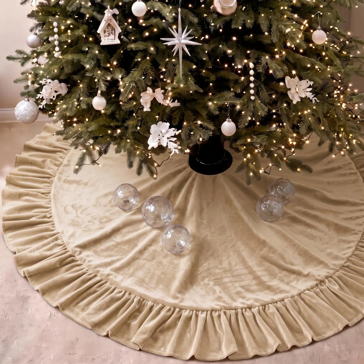 A festive velvet Christmas tree skirt with a ruffled edge surrounding a decorated evergreen tree.