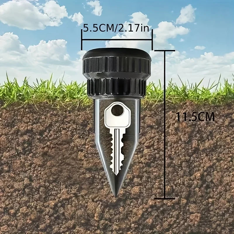 A silver key-shaped garden stake with a black cap is shown inserted into dark soil.