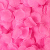 A close-up of vibrant pink silk rose petals scattered densely.