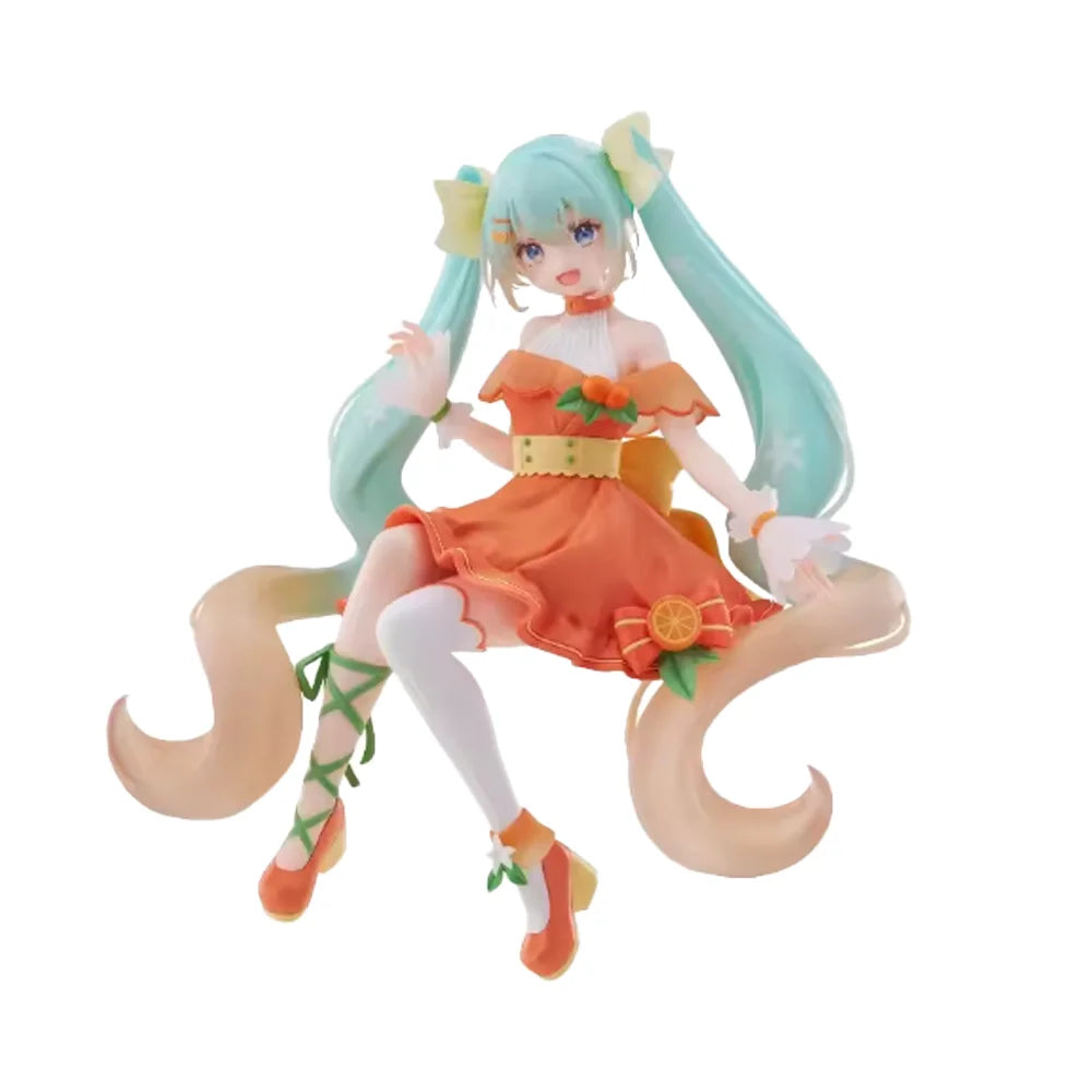 A PVC collectible figurine of Hatsune Miku with long teal hair and an orange outfit.