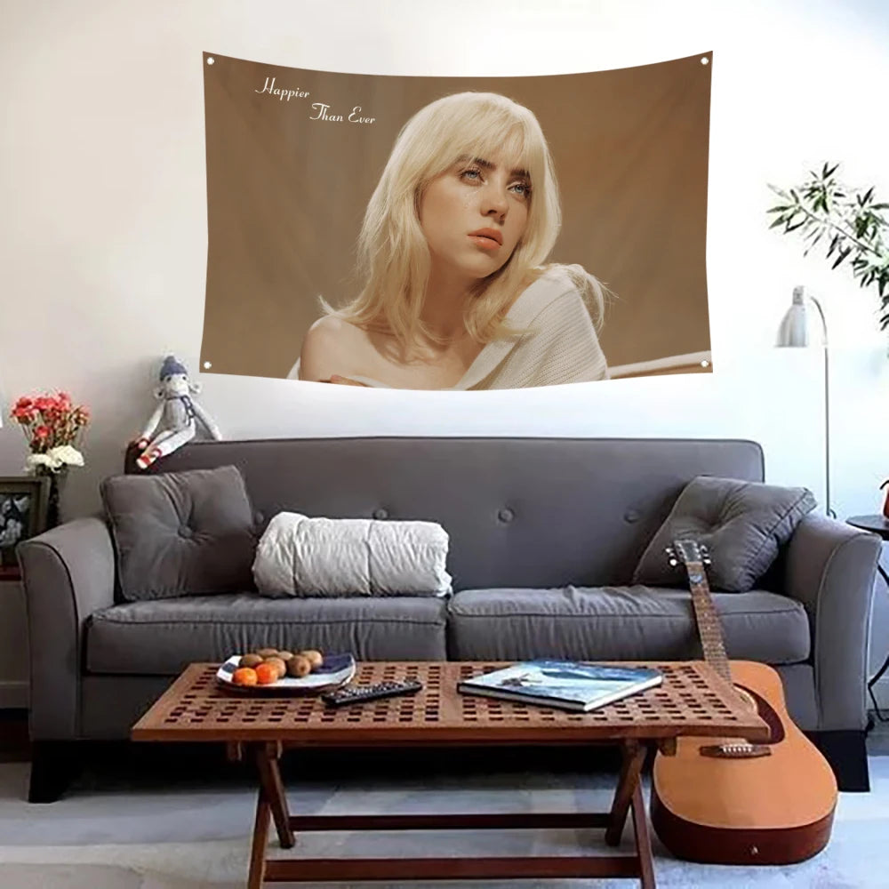 Una mujer de cabello rubio es la protagonista de una gran bandera tapiz colgada sobre un sofá gris y una mesa de centro de ma