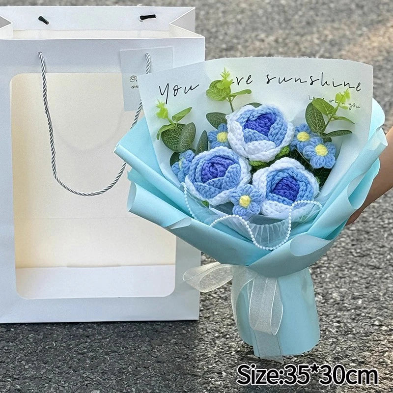 A bouquet of handmade crochet flowers in blue and purple hues with a handwritten message