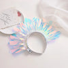 A sparkling iridescent LED glowing headband is displayed on a white surface next to a card.