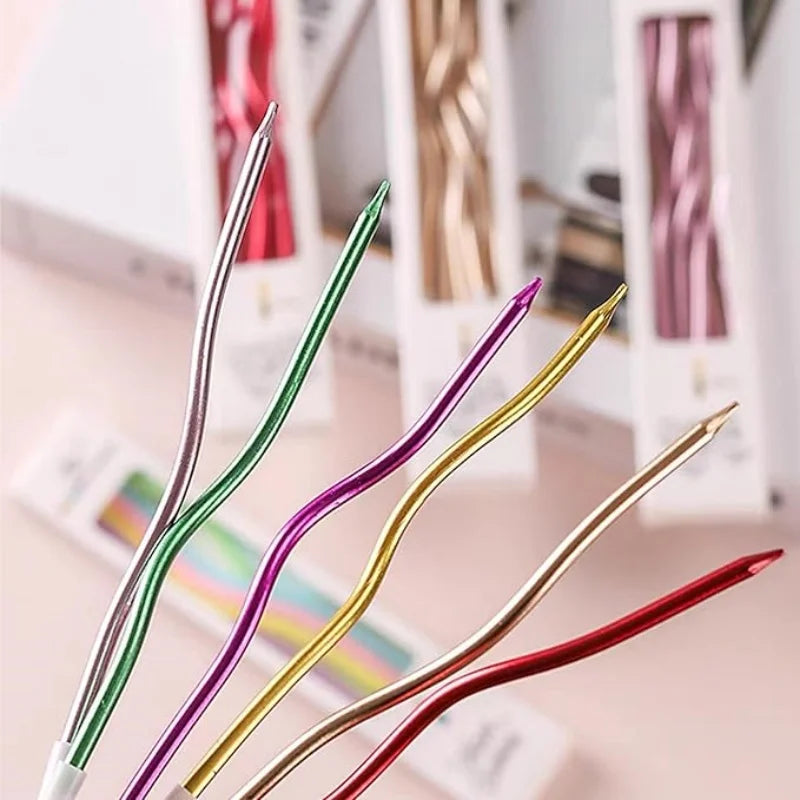 A set of six metallic twisted coil birthday candles in various colors, including green, purple, gold, and red.