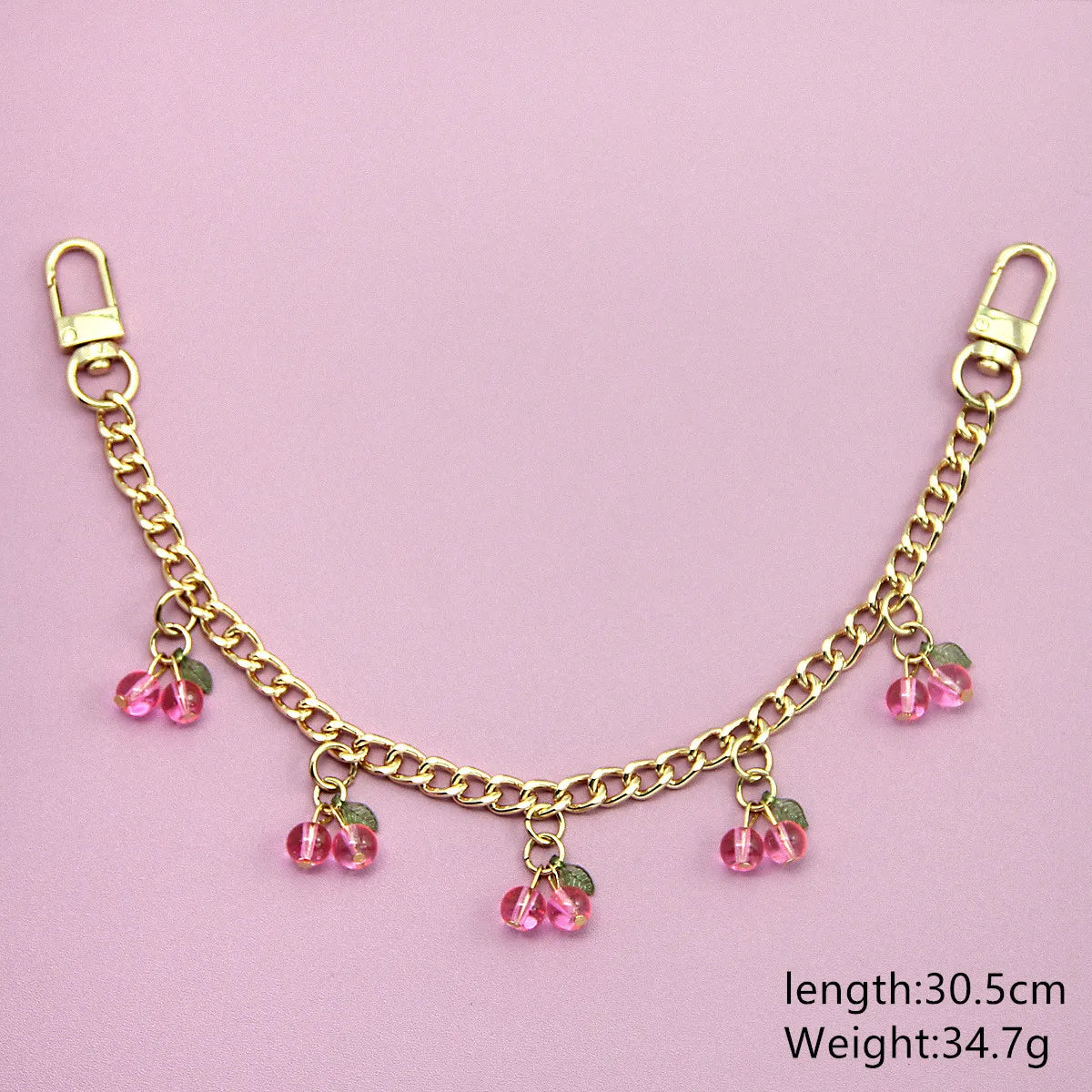 Gold chain necklace with pink cherry charms and a clasp, measuring 30.5cm long and weighing 34.7g.