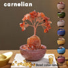 A natural crystal money tree with a rose quartz base growing from a bowl.