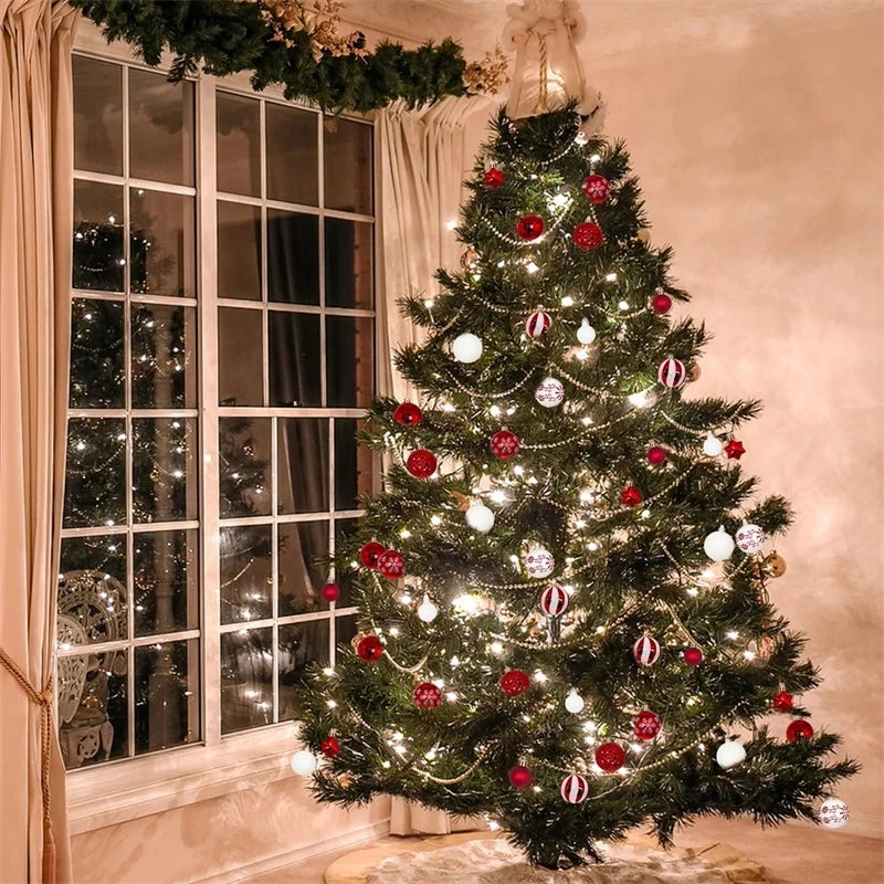 A decorated Christmas tree adorned with red and white ornaments and lights in a room next to a window