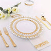 A set of gold disposable cutlery including forks, spoons, and knives displayed on a white plate and napkin.
