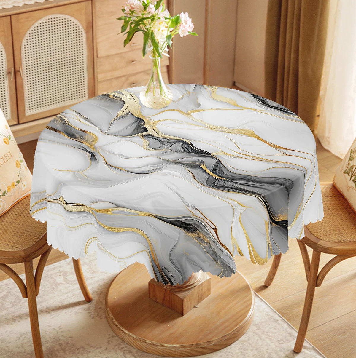 Marble-printed round tablecloth featuring black, gray, and gold ink textures on a wooden stand.