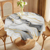 Marble-printed round tablecloth featuring black, gray, and gold ink textures on a wooden stand.