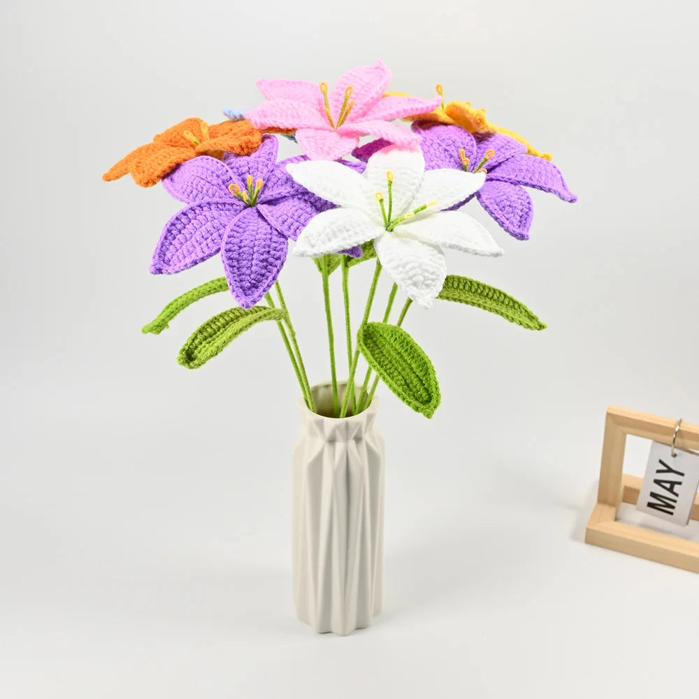 Hand-crocheted artificial lily bouquet featuring purple, pink, and white flowers in a vase