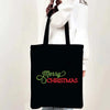 Black tote bag with green text that reads Merry Christmas