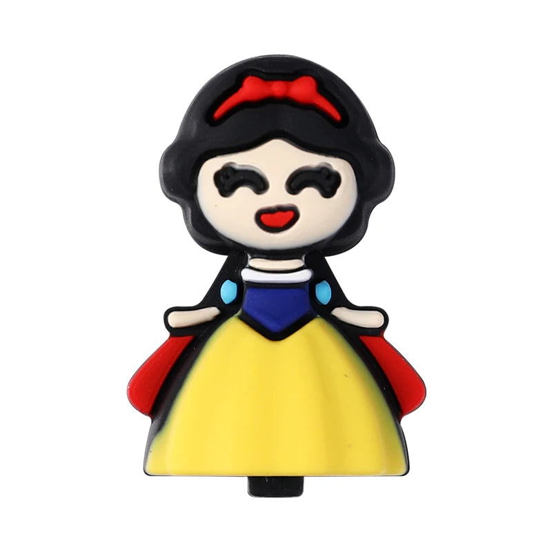 A small, stylized black silicone bead shaped like a woman with black hair and a red bow, wearing a yellow dress with blue acc
