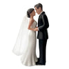 A bride and groom cake topper featuring a couple embracing in a romantic pose.