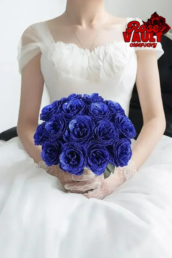 A bouquet of deep blue glitter artificial roses held by a person in a white top.