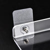 Clear acrylic floating shelf with a wall mount attached to a dark surface.