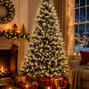 A flocked artificial Christmas tree decorated with warm white LED lights in a cozy indoor setting.