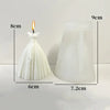 White silicone mold shaped like a wedding dress used for making candles or chocolate.