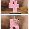 Two pink glitter birthday candles shaped like the numbers 4 and 5 with silver crowns
