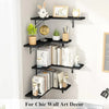 Black corner-mounted wood floating shelves displaying various decorative items like clocks plants and books