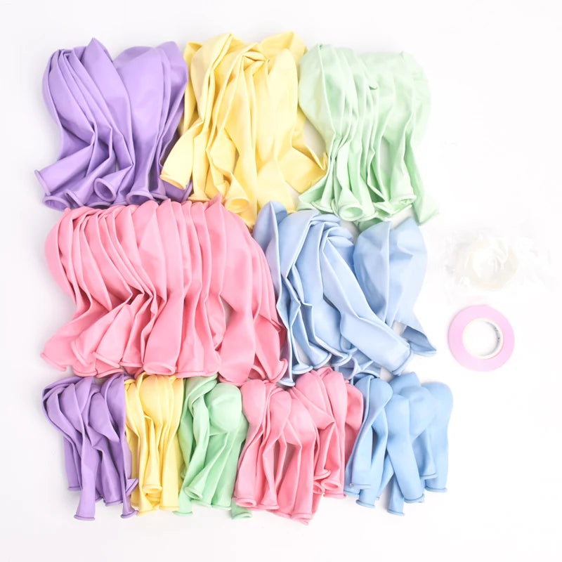 A collection of colorful fabric streamers and ribbons in shades of purple, yellow, pink, and mint green.
