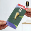 A FIFA 2026 World Cup trophy fridge magnet packaged in a cardboard holder.