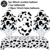 A set of cow print number balloons and a tablecloth for a farm-themed birthday party decoration.
