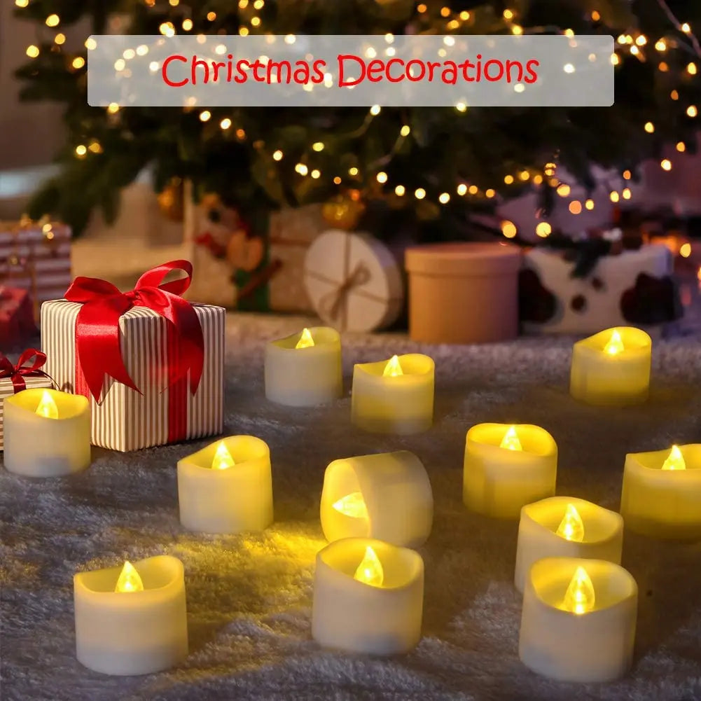 A collection of glowing white votive tea lights arranged on a fuzzy surface with Christmas decorations in the background.
