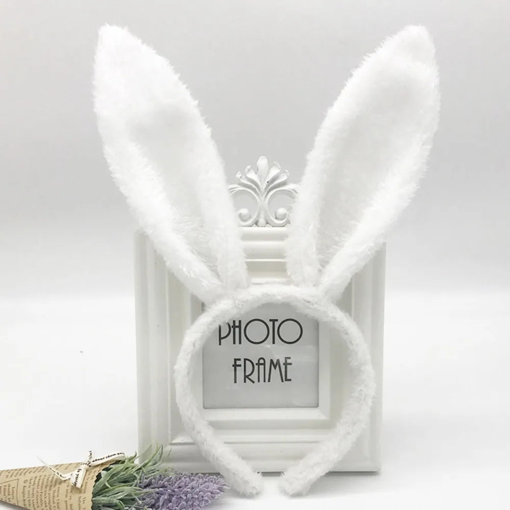 White fluffy bunny ear headband displayed in a white picture frame.