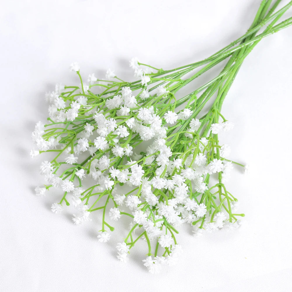 A bunch of artificial baby's breath flowers in bright green on a white background.