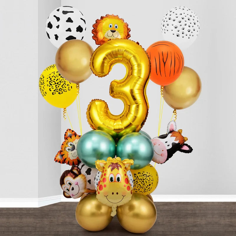 A collection of gold and orange balloons shaped like the number three and various jungle animal figures for a birthday decor 