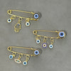 Elegant gold and silver evil eye brooch pin featuring various eye motifs and dangling charms.