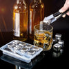 Reusable stainless steel ice cubes being dropped into a glass of iced tea