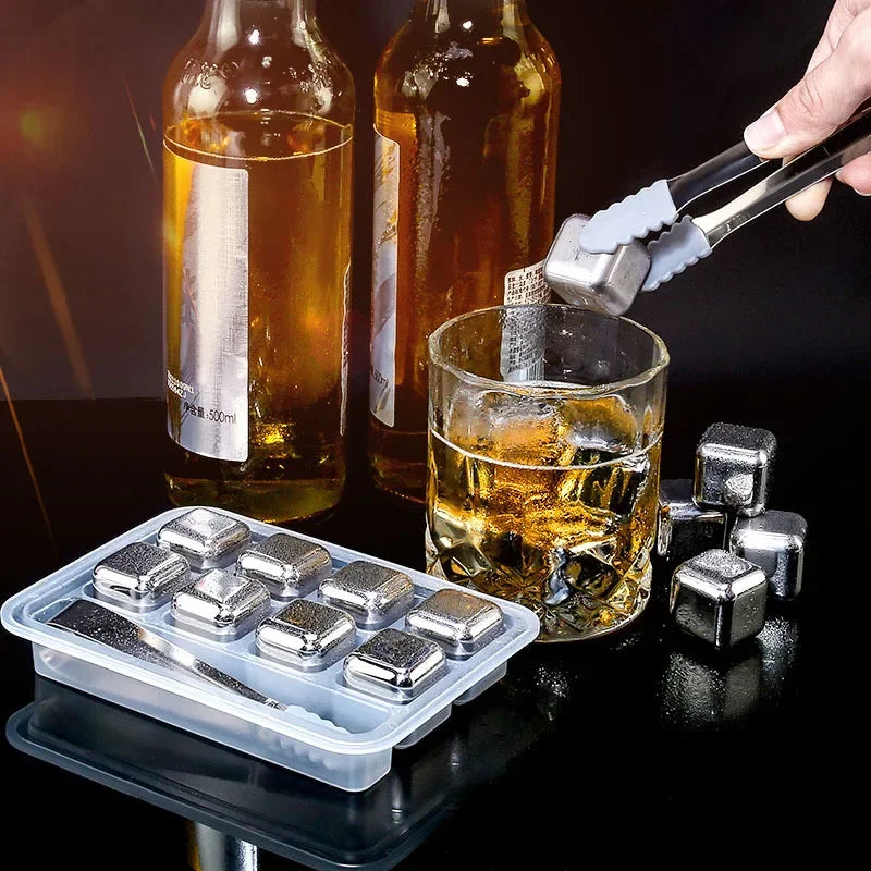 Reusable stainless steel ice cubes being dropped into a glass of iced tea