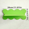 A bright lime green cherry-shaped wooden wall shelf with a small rectangular cutout.