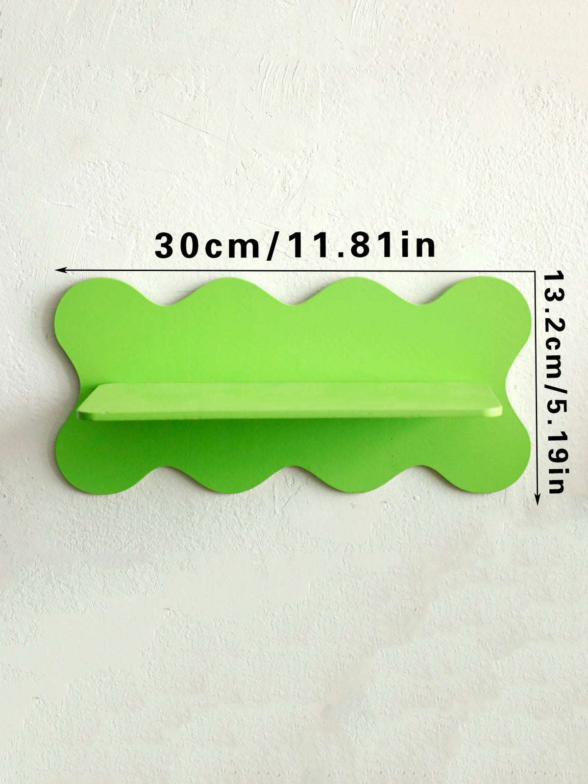 A bright lime green cherry-shaped wooden wall shelf with a small rectangular cutout.