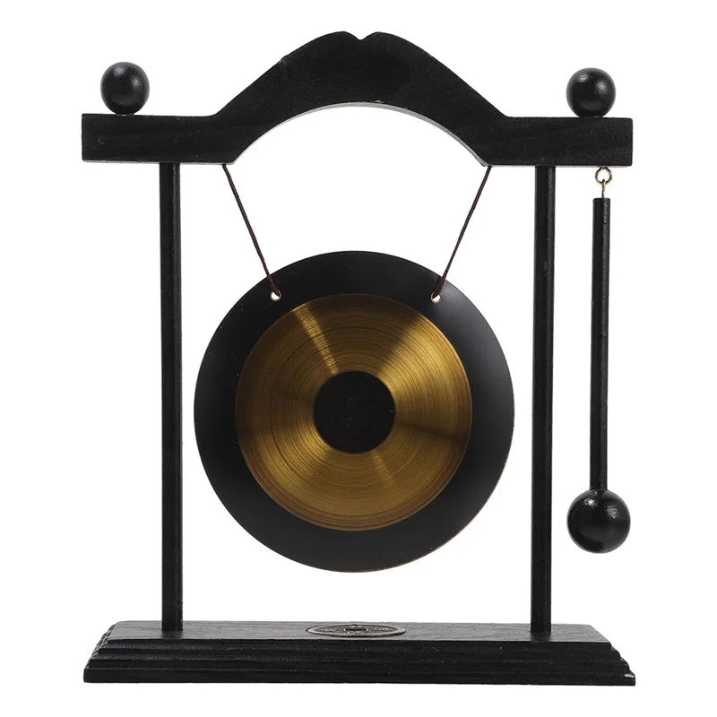 A black and brass gong decor set featuring a large circular gong suspended by a stand.