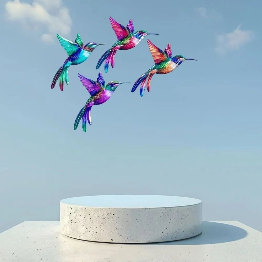 A group of iridescent hummingbird wall art featuring vibrant greens, purples, and pinks against a light blue sky.
