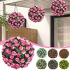 A collection of artificial rose ball decorative floral spheres in various shades of pink and green.