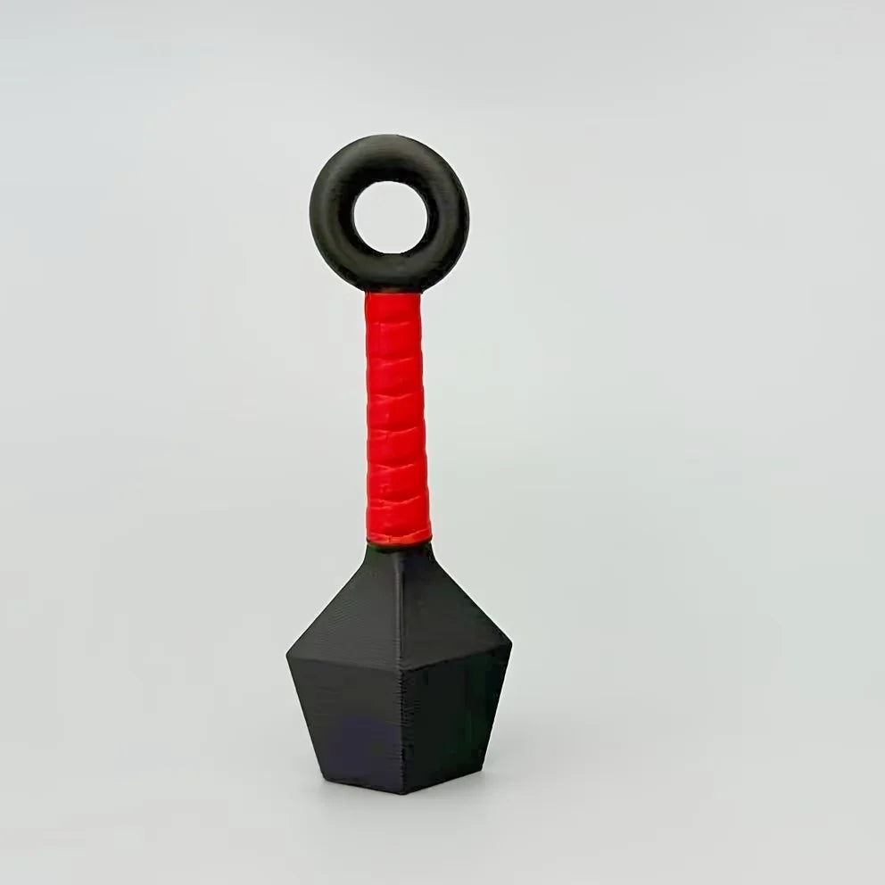 A black and red ninja dart refrigerator ornament with a circular loop top and a pyramid base.