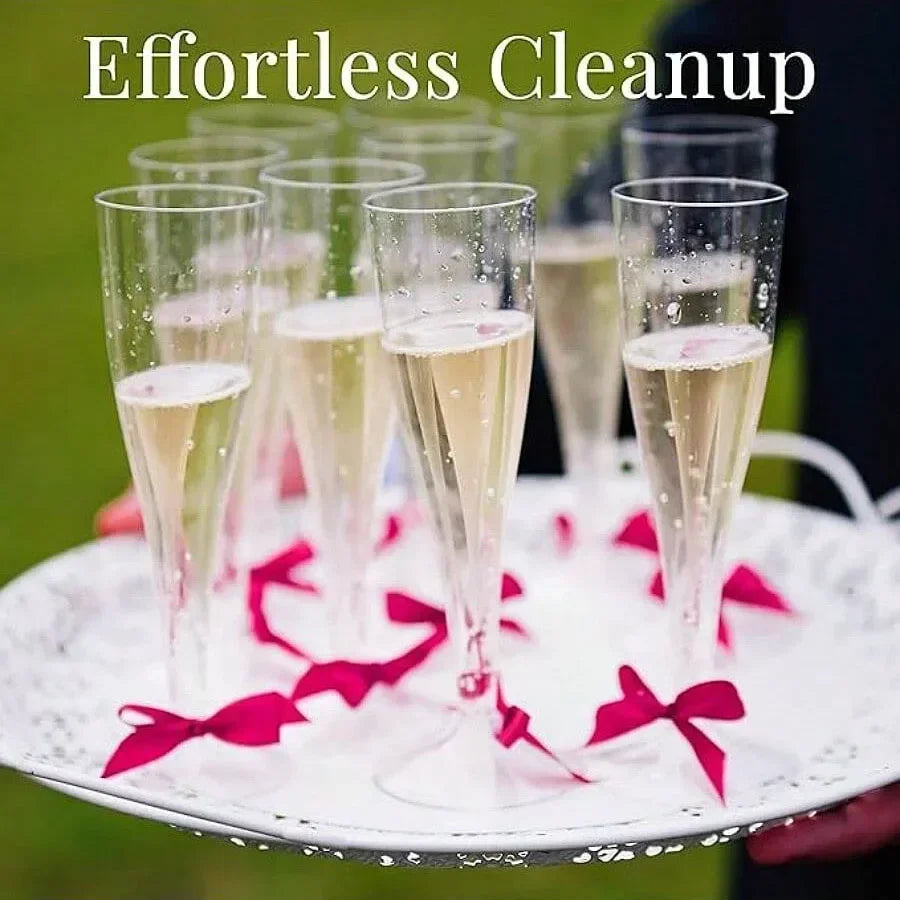 A set of disposable champagne glasses with a gold finish are displayed on a white plate.