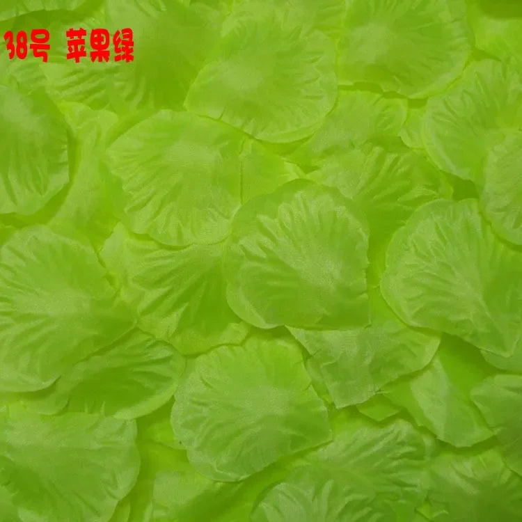 A close-up of bright lime green silk rose petals for weddings and events.