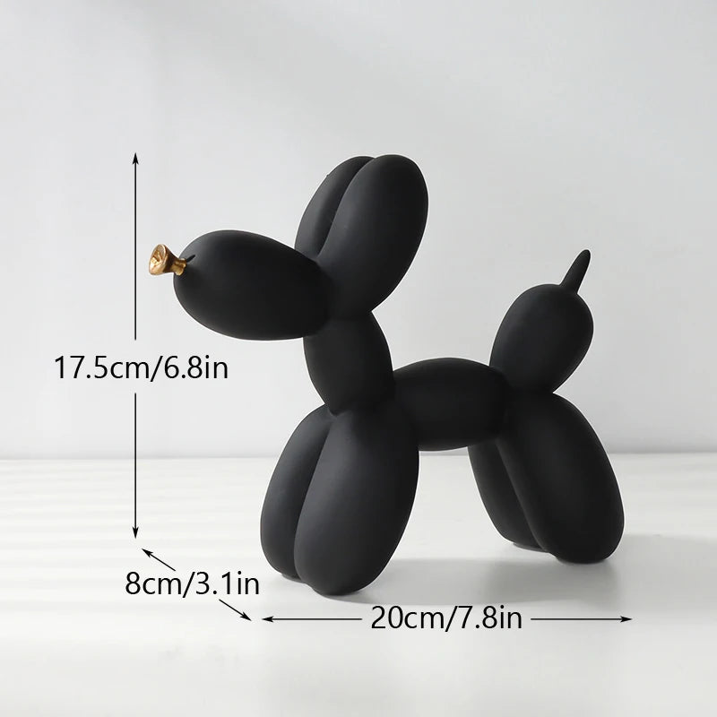 A black resin sculpture of a dog shaped like a balloon, displayed on a white surface.