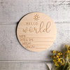 A round wooden sign with the words Hello world and lines for name, date & time, weight, and length.