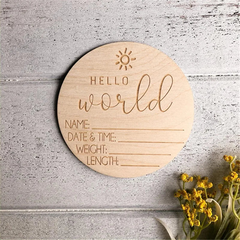 A round wooden sign with the words Hello world and lines for name, date & time, weight, and length.