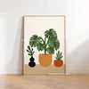 Botanical philodendron canvas wall art featuring a green plant in an orange pot on a neutral background.