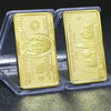 Two gold plated 100 dollar paper currency notes in protective plastic holders.